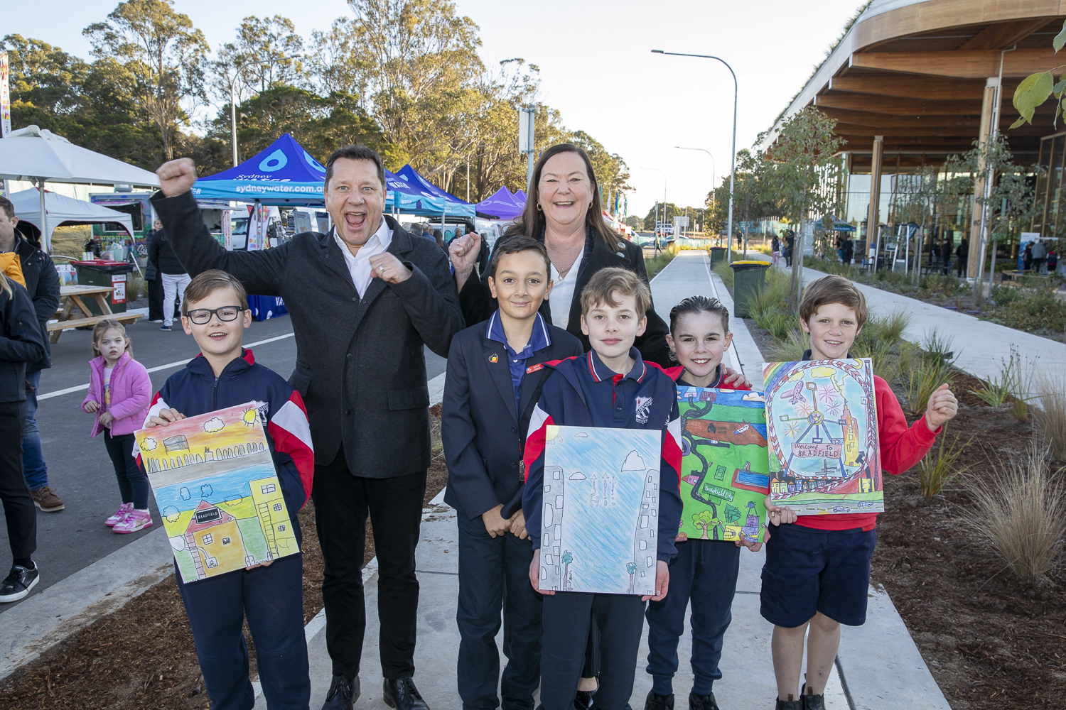 Minister Paul Scully and kids from Luddenham Public School pose with artworks at Bradfield's First Building.