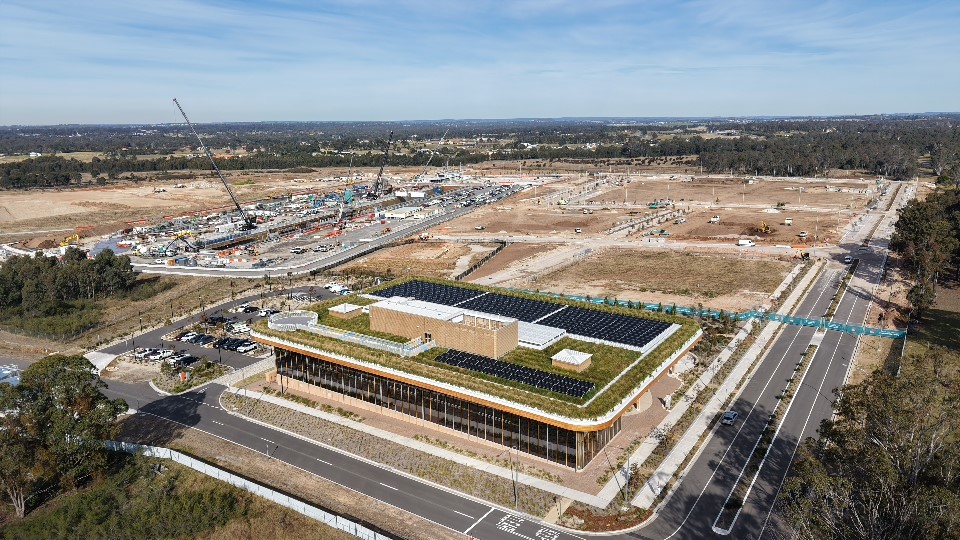 Aerial view of Bradfield City First Building with construction works in the background.