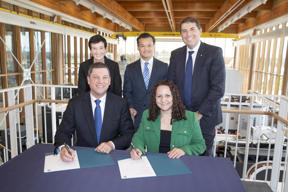 Five business people signing agreement