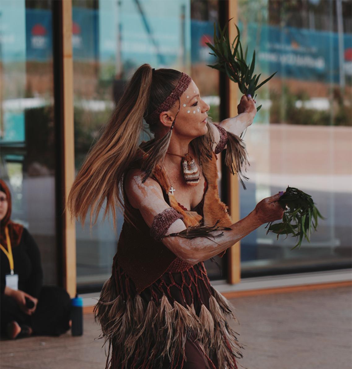 An Indigenous dancer performing at First Building