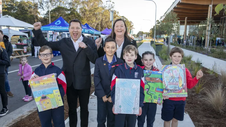 Minister Paul Scully and kids from Luddenham Public School pose with artworks at Bradfield's First Building.