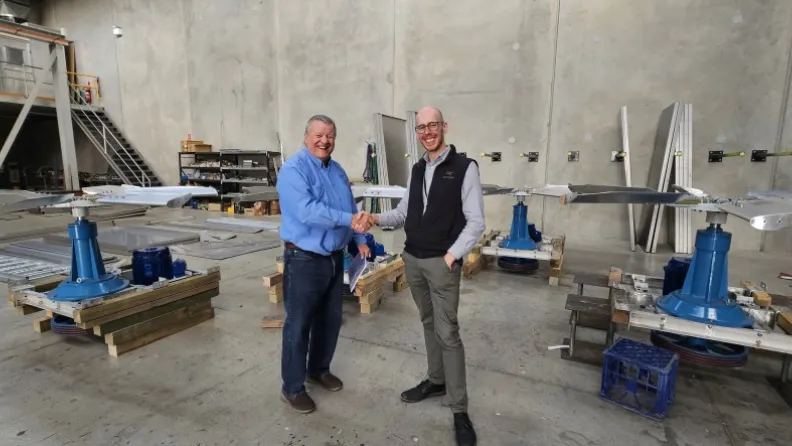 Gareth Jones, director of Marley Flow, and Ben Kitcher, Executive Director AMRF, shake hands..