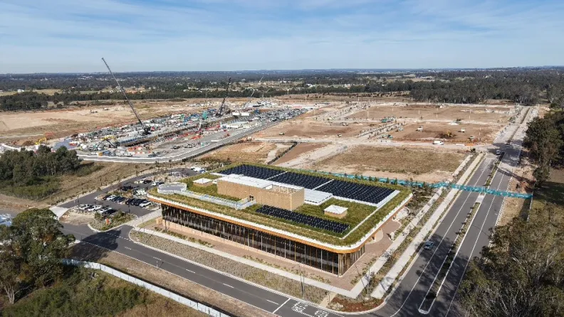 Aerial view of Bradfield City First Building with construction works in the background.