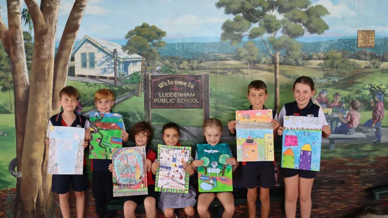 Children holding their artworks