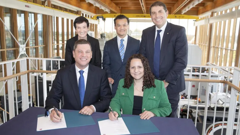 Five business people signing agreement