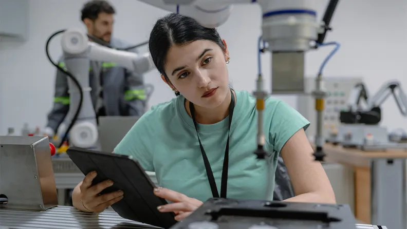 A researcher working with a robotic arm
