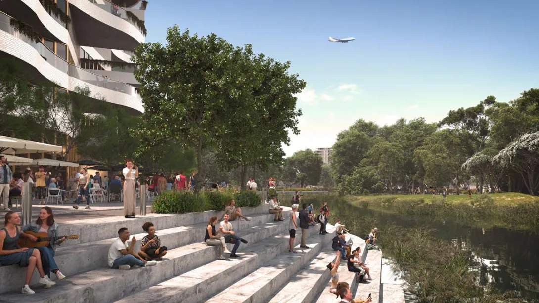 People sitting on steps leading down to a city waterfront