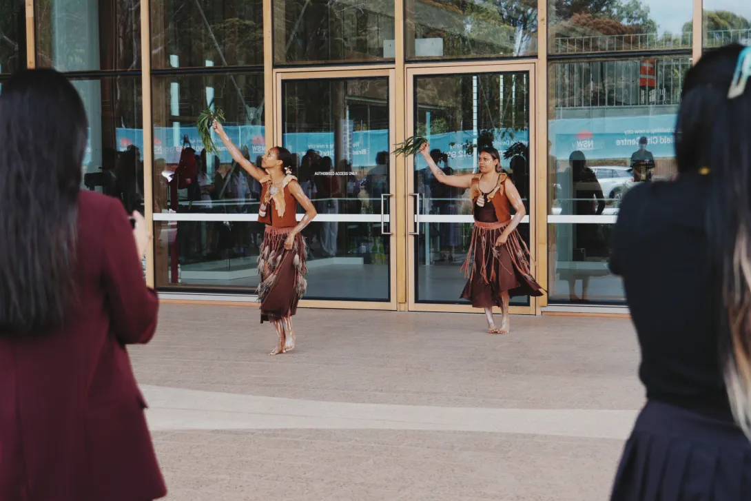 Two dancers perform outside First Building at Bradfield City