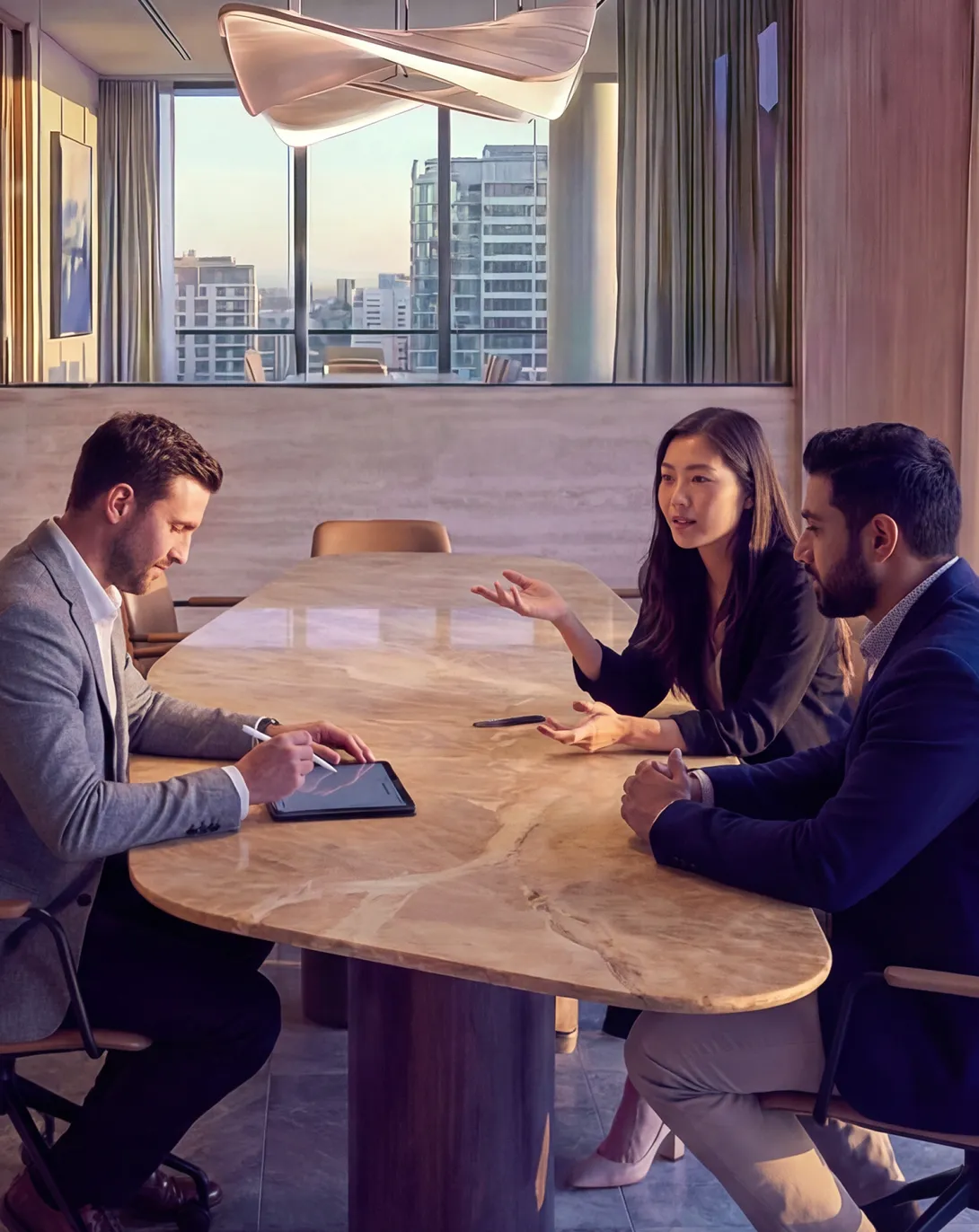 Three office workers at a meeting table